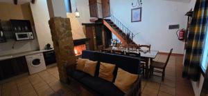 a living room with a dining table and a fireplace at Casas Rurales Cortijos el Encinar in Torres