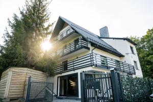 a house with a black and white house at Szafran Home Spa in Korbielów