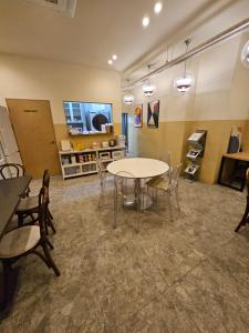 a room with a table and chairs in it at T hotel in Seoul