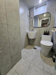 a bathroom with a toilet and a sink and a mirror at T hotel in Seoul +57 photos