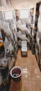 a small bathroom with a toilet and a sink at Hotel Tirumala Vaibhav in Secunderabad