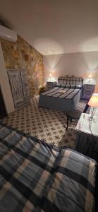 a hotel room with two beds and a stone wall at Casas Rurales Cortijos el Encinar in Torres +94 photos