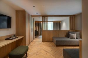 a hotel room with a bed and a television at Hotel Gampen in Solda