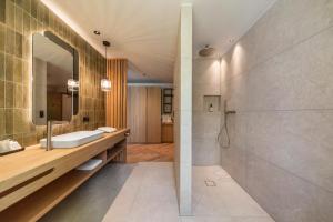 a bathroom with a sink and a mirror at Hotel Gampen in Solda +61 photos