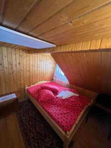 a room with a bed in a wooden cabin at Cabana Adelin in Dobreşti +24 photos