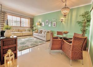 a living room with a couch and a table and chairs at MyOcean Luxury l Huge Panoramic Sea View Balcony & Private Garage in Portimão +38 photos