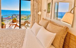 a bedroom with a bed with a view of the ocean at MyOcean Luxury l Huge Panoramic Sea View Balcony & Private Garage in Portimão