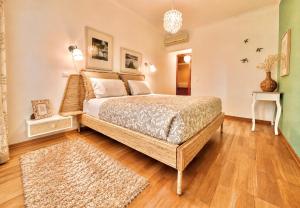 a bedroom with a large bed and a wooden floor at MyOcean Luxury l Huge Panoramic Sea View Balcony & Private Garage in Portimão