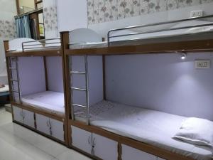 a group of bunk beds in a room at C N Comforts Hotel & Dormitory in Lucknow +10 photos