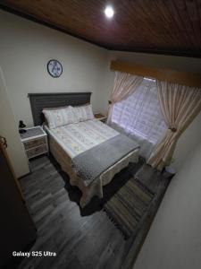 a bedroom with a bed and a clock on the wall at 5@Stock Accommodation in Bloemfontein