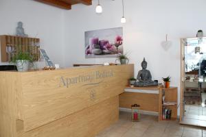 a shop with a wooden counter with a sign on it at Bolfenk B6 in Hočko Pohorje