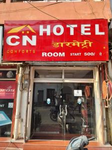 a red sign on top of a store at C N Comforts Hotel & Dormitory in Lucknow