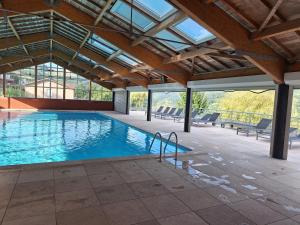 a large swimming pool with a glass ceiling at Les Abeilles in Trébas