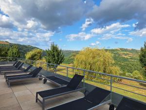 a row of chairs sitting on a balcony with a view at Les Abeilles in Trébas