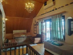 a living room with a couch and a chandelier at Mahmud Guest House in Sheki