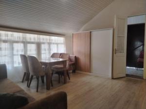 a dining room with a table and chairs at Mahmud Guest House in Sheki