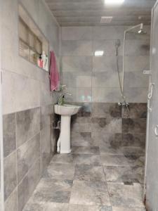 a bathroom with a sink and a shower at Mahmud Guest House in Sheki +16 photos