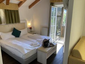 a hotel room with a bed and a balcony at Alpen Hotel Eghel Resort & SPA in Folgaria +74 photos