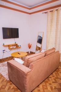 a living room with a couch and a table at MERED Haven Studio in Kilifi