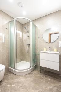 a bathroom with a shower and a toilet and a sink at Vilaverona in Palanga +62 photos