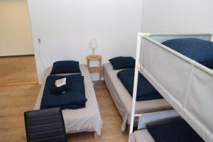 a room with two bunk beds and a table at Neckelmanns BnB Room 37 in Aalborg