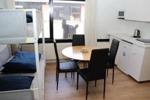 a small room with a table and chairs and a bunk bed at Neckelmanns BnB Room 37 in Aalborg +5 photos
