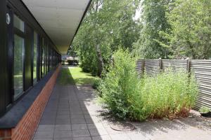 a building with a walkway next to a fence at Neckelmanns BnB Room 37 in Aalborg