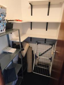a small room with a shelf and a refrigerator at Bochum Wohnung in Bochum