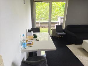 a living room with a white table and a couch at Bochum Wohnung in Bochum