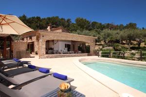 a villa with a swimming pool and a house at Villa Alordes in Pollença