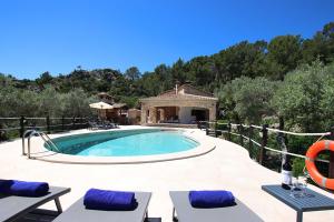 a swimming pool with a villa in the background at Villa Alordes in Pollença