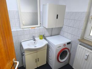 a small bathroom with a washing machine and a sink at Bochum Wohnung in Bochum +21 photos