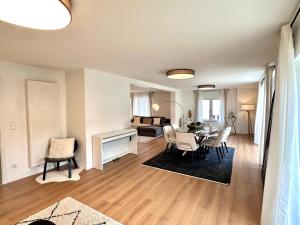 a living room with a table and chairs and a couch at Modern Country House in Merzig +6 photos