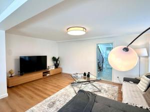 a living room with a couch and a tv at Modern Country House in Merzig