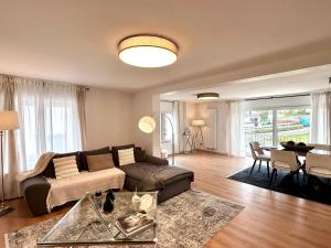 a living room with a couch and a table at Modern Country House in Merzig