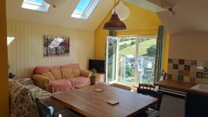 a living room with a table and a couch at Valley View Haven in Kingsbridge