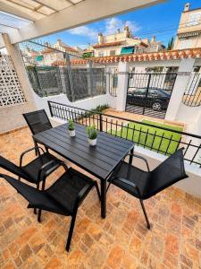 a black table and chairs on a patio at Villa Belén . in El Moncayo