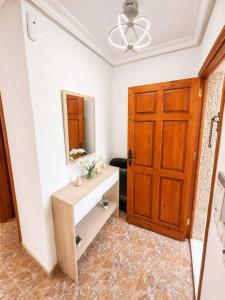 a bathroom with a mirror and a wooden door at Villa Belén . in El Moncayo