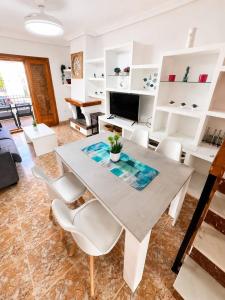 a living room with a table and white chairs at Villa Belén . in El Moncayo +75 photos