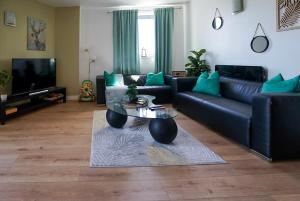 a living room with a couch and a coffee table at Stylish 2-Bed Apartment, Free Parking, Walk to Hospital & Uni in Sheffield