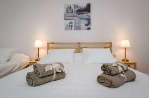 a bedroom with two beds with towels on the bed at Luxury Beachfront Villa Kata in Rogotin
