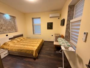 a bedroom with a bed and a chair in it at Етаж от къща в Разград in Razgrad