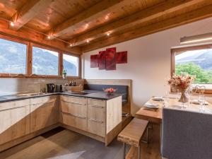 a kitchen with wooden cabinets and a table with a table sidx sidx sidx at Ferienwohnung Schwarzenauer in Fügen