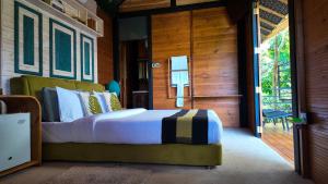 a bedroom with a bed in a wooden room at O2 Villas Ella in Ella +108 photos