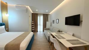 a hotel room with a bed and two tables and a couch at HotelApart - DelMar in Durrës +50 photos