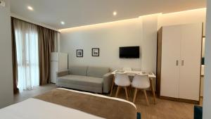 a living room with a couch and a table at HotelApart - DelMar in Durrës