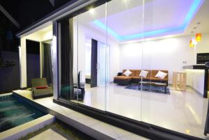 a living room with a couch and a pool at Rocking Chair Pool Villa in Chaweng