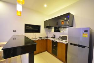 a kitchen with a refrigerator and a counter top at Rocking Chair Pool Villa in Chaweng