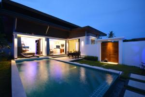 a house with a swimming pool at night at Rocking Chair Pool Villa in Chaweng