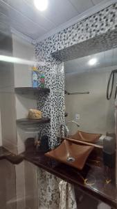 a bathroom with a sink and a mirror at L&S casa da lagoa in Búzios